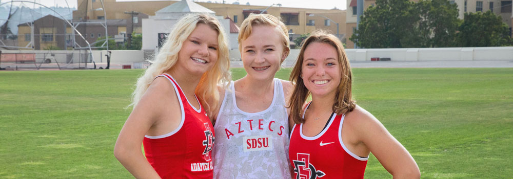 Three Adapted Athletics track and field team players smiling
