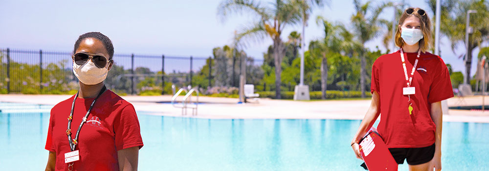 Two lifeguards in face masks at Aquaplex pool