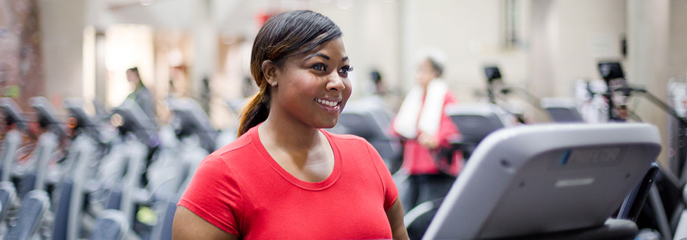 Woman on elliptical machine in cardio room at ARC
