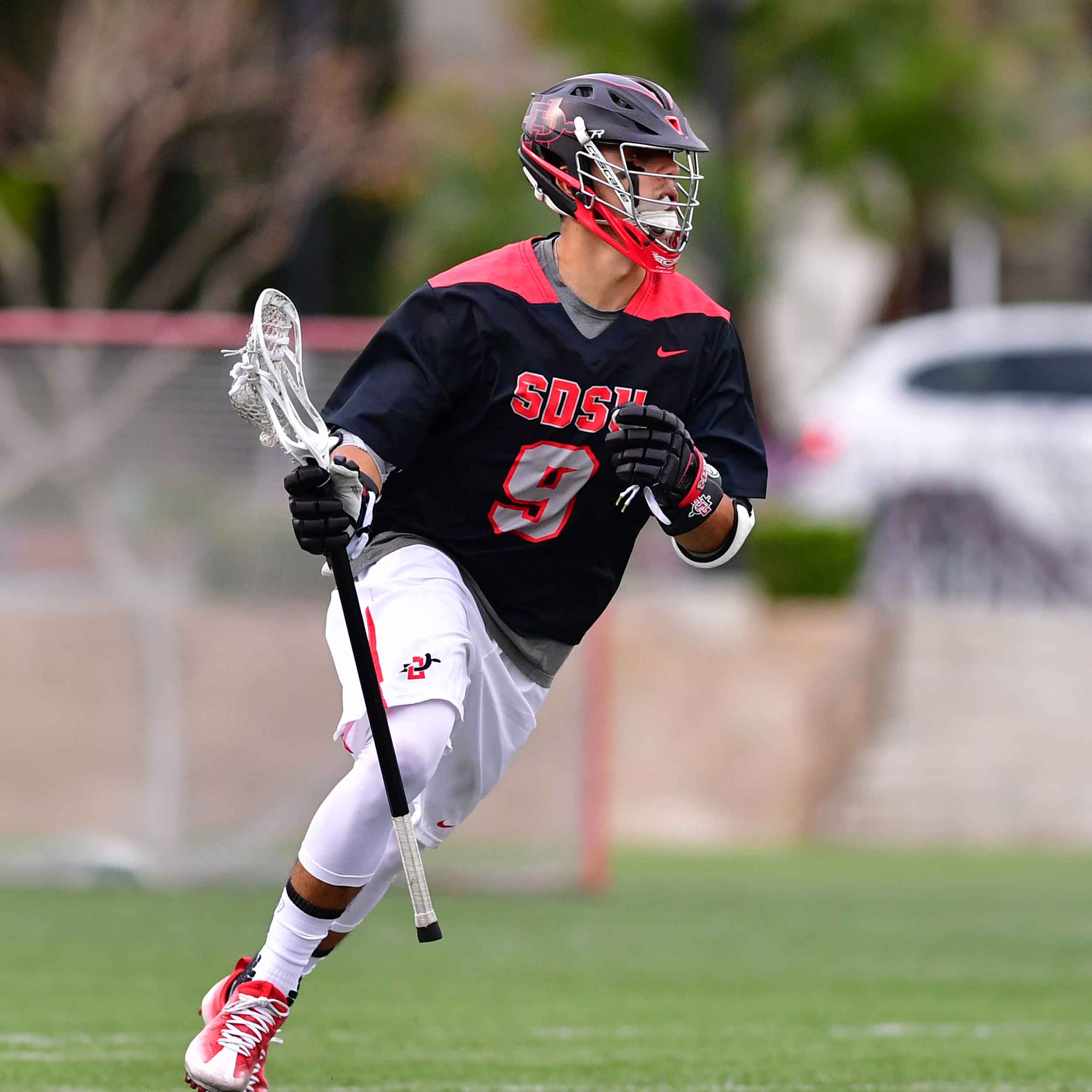 Men's Lacrosse player running on the field during a game